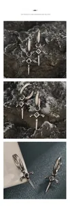 Macro detail of sword-shaped drop earrings with black zircon in vintage silver finish