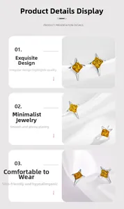 Gros plan de boucles d'oreilles en étoile dorée avec résine orange et cadre poli