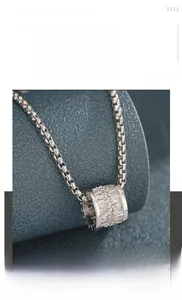 Macro view of titanium steel box chain and cylinder pendant with pavé crystals