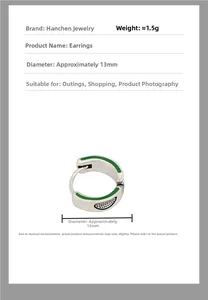 Macro view of silver earring with green enamel and dot pattern, diameter 13mm