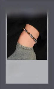 Detailed macro of vintage beaded bracelet featuring silver pieces and tiger eye stones
