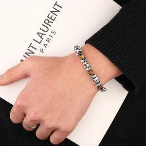 Beaded bracelet with irregular silver metal beads and faceted tiger eye stones on wrist