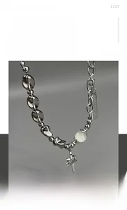 Detailed close-up of a silver stainless steel hip-hop necklace with cross sword pendant