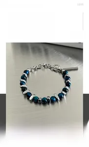 Detailed view of dark blue stone beads with titanium steel spacers and lobster clasp