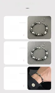 Detail of beaded hematite bracelet with twisted silver metal links and extension chain