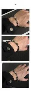 Detail view of hematite beads and twisted silver metal beads on a minimalist bracelet