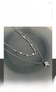 Detail view of silver double-layered titanium steel necklace with blue star pendant