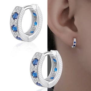 Minimalist silver hoop earrings with blue zircon and white diamonds in a split view