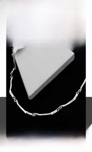 Detail of silver irregular titanium steel wave necklace with unique branch-like links
