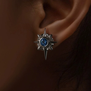 Star-shaped silver stud earring featuring a vibrant blue sapphire gemstone for men and women