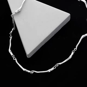 Minimalist wave-shaped titanium steel necklace with a liquid metal aesthetic and silver finish