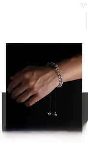 Macro detail of adjustable crystal beaded bracelet with marble stone accents and woven cord