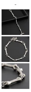 Macro detail of bone-shaped link bracelet with vintage silver finish and OT clasp toggle