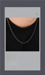 Close-up of minimalist black twist rope chain necklace worn by a model in a studio