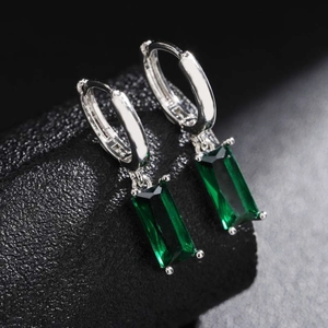 Elegant silver earrings with rectangular emerald stones in a four-prong setting