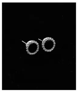 Macro shot of silver crystal stud earrings featuring 360-degree mirror polished finish