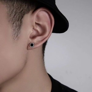 Unisex black circular stud earrings with silver diamond edges in a minimalist fashion style