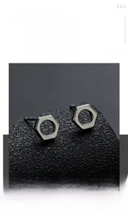 Macro shot of industrial style hexagonal nut earrings in gun black polished metal