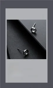 Detailed view of silver hexagonal nut stud earrings with industrial metallic texture