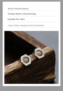 Macro detail of silver hexagonal nut stud earrings for men on a vintage wooden box