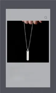 Macro shot of silver rectangular prism pendant on square pearl chain necklace