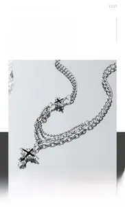 Detailed view of hip-hop layered titanium steel necklace with black enamel cross pendant