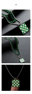 Close-up of a double-layered necklace with green checkerboard pendant and dual chains
