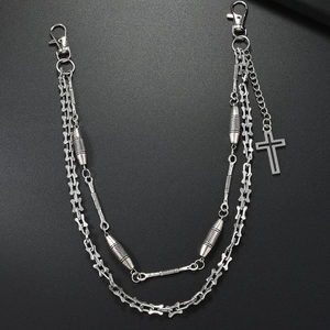 Detail of silver double-layered hip hop pants chain with bone links and cross pendant