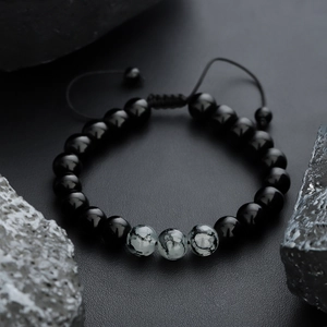Adjustable tiger eye stone beaded bracelet with hand-woven cord and polished black beads