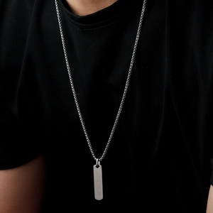 Minimalist silver box chain necklace with rectangle pendant worn on a black T-shirt