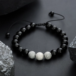 Tiger eye and black onyx beaded bracelet with adjustable woven cord on dark stones