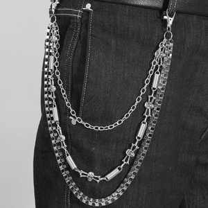 Detail of silver multi-layer hip hop wallet chain with skull charms and checkered pattern