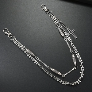 Double-layered punk metal waist chain with cross pendant and bone links on black background