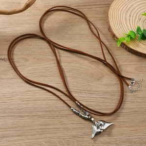 Silver heart pendant woven rope necklace with bohemian design on wood background