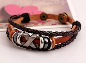 Close-up of retro punk layered leather bracelet with metal accents and wooden beads
