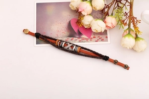 Detail of vintage multilayer braided leather bracelet with metal accents and snap button
