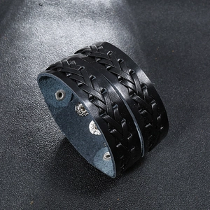 Close-up of black braided leather cuff with triple silver snap buttons for size adjustment