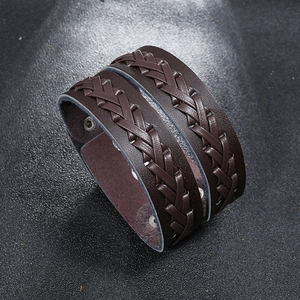 Close-up of dark brown double-layer braided leather bracelet with vintage metal rivets