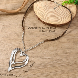 Large double-layer hollow heart pendant necklace with brown woven cord on wood background
