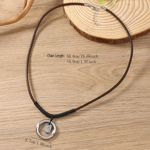 Collier avec pendentif chouette vintage et cordon en cuir sur fond en bois naturel