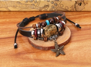 Detailed close-up of layered leather bracelets with wooden beads and starfish pendants