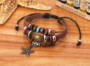 Detail of vintage layered leather bracelet with wooden beads and starfish pendant