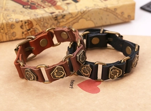 Detail of vintage leather bracelets with scorpion metal plate and snap button closures