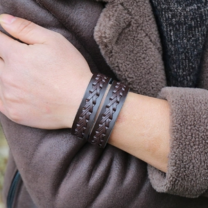 Macro shot of dark brown braided leather bracelet featuring vintage punk style textures