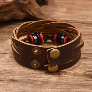 Detail of vintage braided leather bracelet with star studs and snap button closure