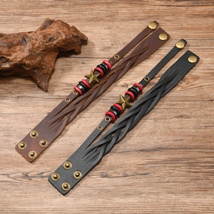 Detail of vintage woven leather bracelets with star charms and adjustable bronze buckles
