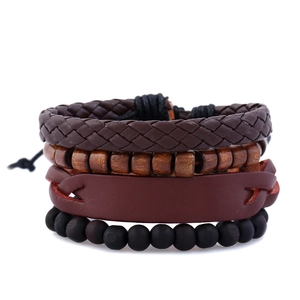 Detail of four-piece set with brown braided leather, wood beads, and vintage wristbands