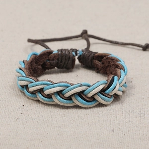 Handmade multilayer braided leather bracelet with adjustable cord on rustic linen background