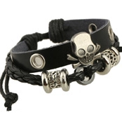 Detail view of a black layered punk leather bracelet with a vintage metal skull and crossbones