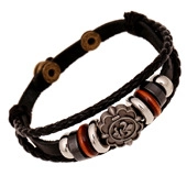 Detail of vintage punk leather bracelet featuring fleur-de-lis charm and multilayer beads